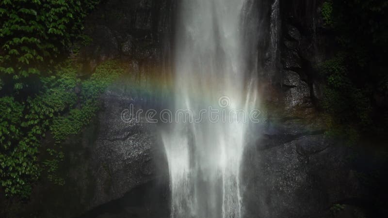 Sekumpul Waterfall in Bali with a rainbow, Indonesia. Slowmotion