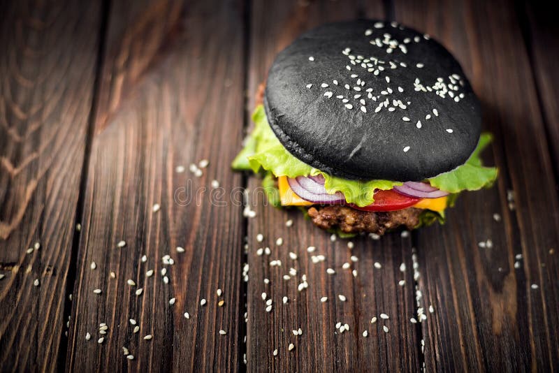 Selbst gemachter schwarzer Burger mit Käse Cheeseburger mit schwarzem Brötchen O stockfoto Selbst gemachter schwarzer Burger mit Käse Cheeseburger mit schwarzem Brötchen O stockfoto