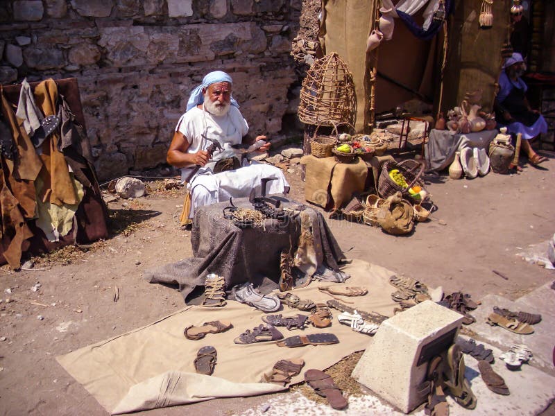 Selcuk, Turkey - June 18 2012 : Actor posing as old artisan shoe maker in Ephesus Ancient City, near Kusadasi. UNESCO World Herita stock photos Selcuk, Turkey - June 18 2012 : Actor posing as old artisan shoe maker in Ephesus Ancient City, near Kusadasi. UNESCO World Herita stock photos