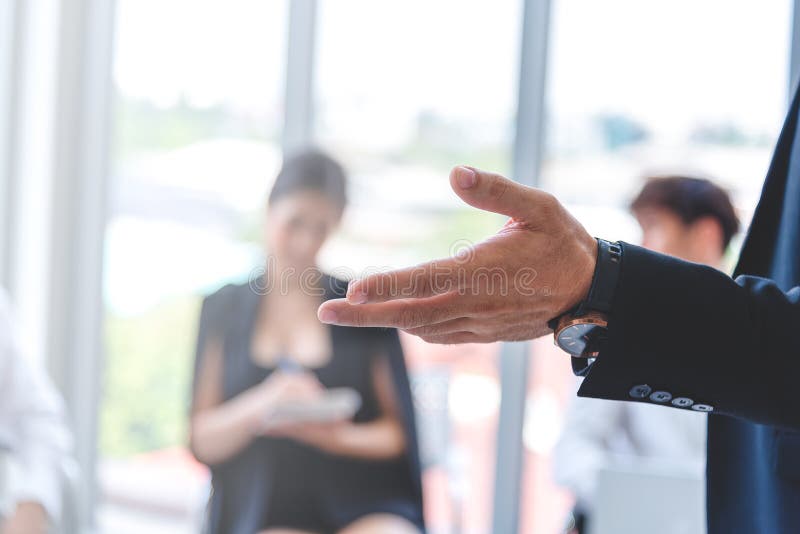 Selected focus on businessman hand opened asking for opinion in the meeting room with blurred background of team member stock images Selected focus on businessman hand opened asking for opinion in the meeting room with blurred background of team member stock images