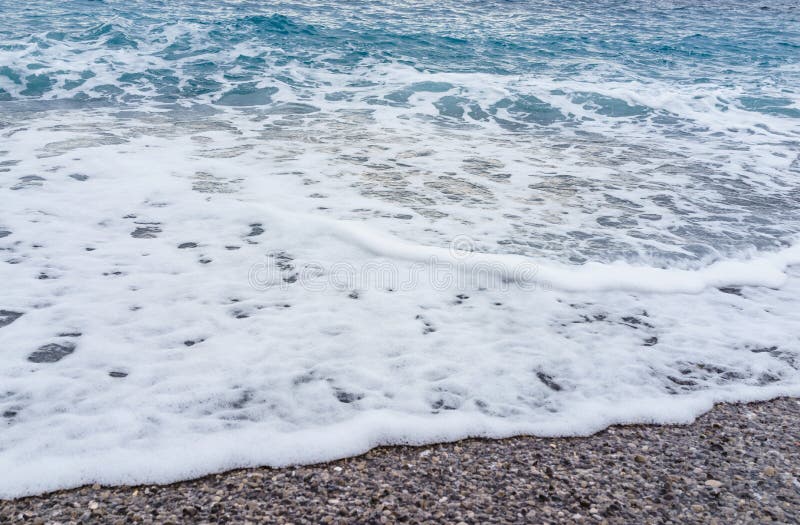 Selective focus Soft gentle waves with foam in blue ocean italy shore summer vacation. Selective focus Soft gentle waves with foam in blue ocean italy shore summer vacation.