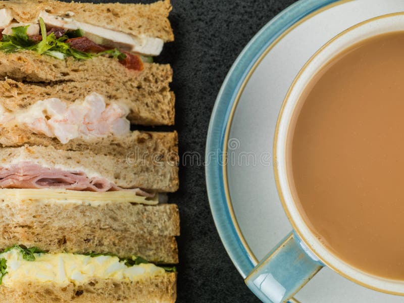 Selection of Assorted Sandwiches in Brown Bread with a Cup of Te Stock