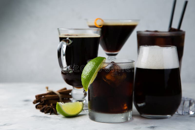 Selection of black cocktails in different glasses, marble background royalty free stock photography Selection of black cocktails in different glasses, marble background royalty free stock photography