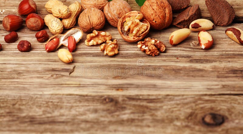 Selection of festive fresh nuts on rustic wood royalty free stock photo Selection of festive fresh nuts on rustic wood royalty free stock photo