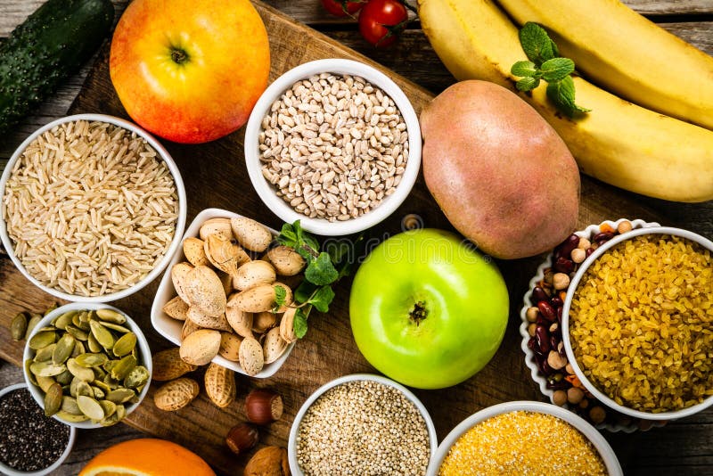 Selection of good carbohydrates sources. Healthy vegan diet. Selection of good carbohydrates sources - vegetables, fruits, grains, legumes, nuts and seeds stock photo