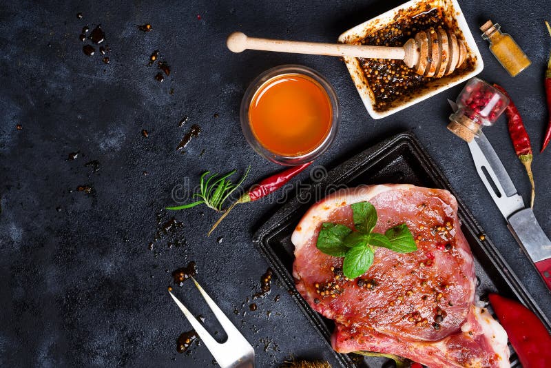 Raw Steaks and Frying Pans with Seasoning, Garnishes and Ingredients on