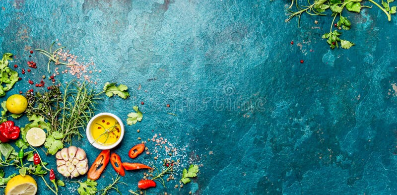 Selection of spices herbs and greens. Ingredients for cooking. Food background on turquioise slate background. Top view stock photography Selection of spices herbs and greens. Ingredients for cooking. Food background on turquioise slate background. Top view stock photography