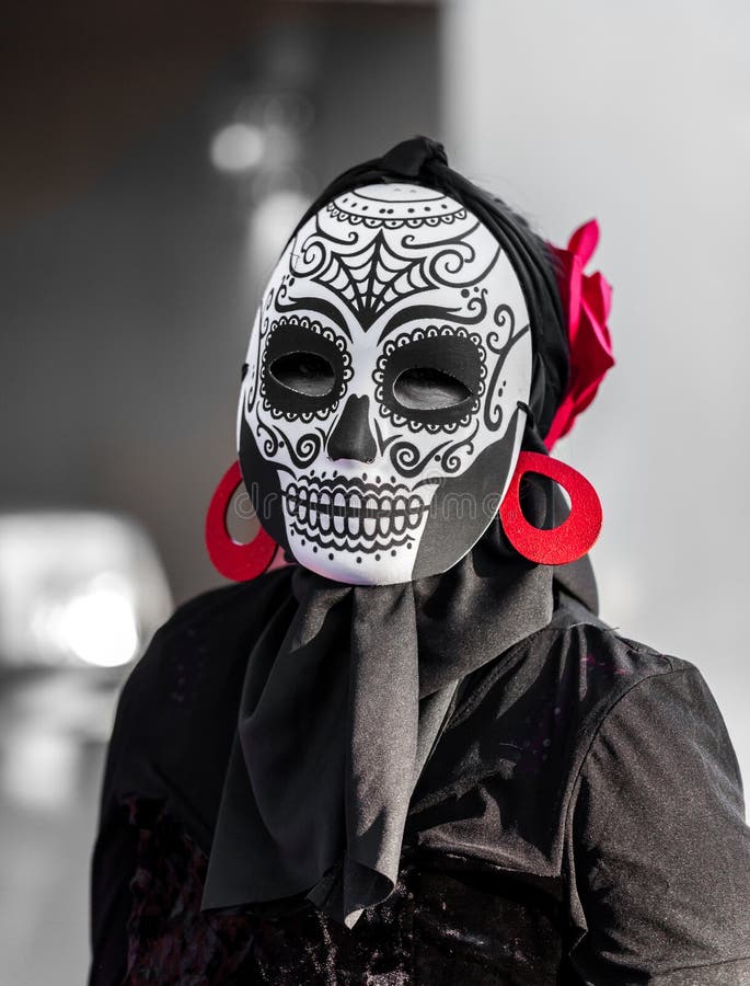 Selective color, black and red, portrait of woman wearing a sugar skull mask for dia de los muertos / day of the dead celebrated stock images Selective color, black and red, portrait of woman wearing a sugar skull mask for dia de los muertos / day of the dead celebrated stock images