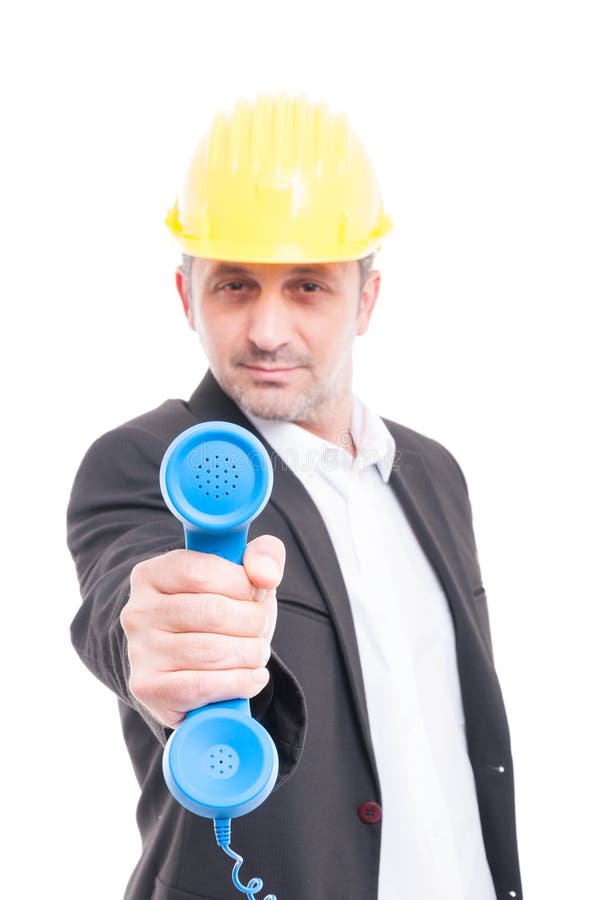 Selective focus of architect showing big blue telephone receiver royalty free stock photography