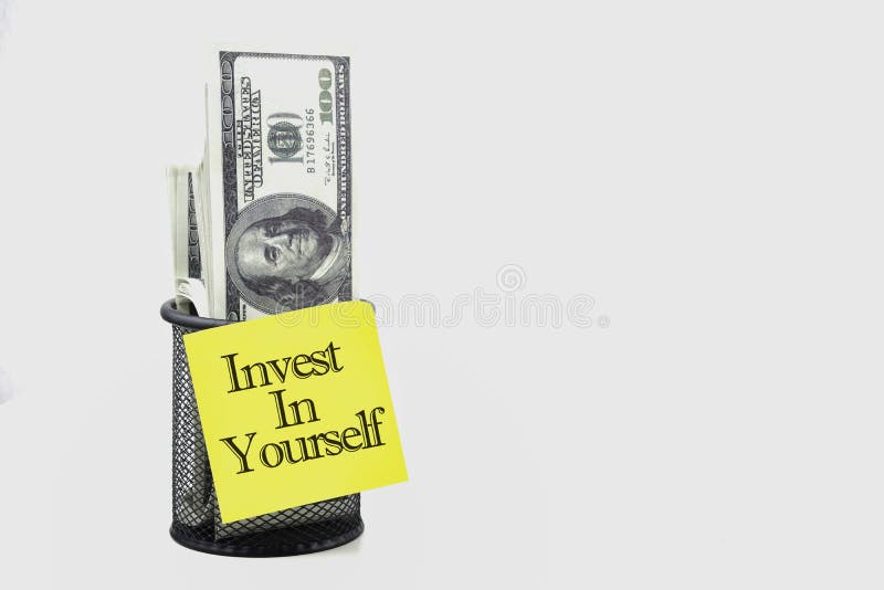 Selective focus of bank note with Invest In Yourself wording on a white background. Economy concept royalty free stock photography