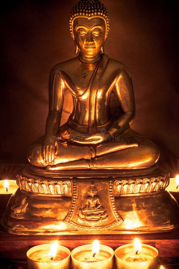 Selective Focus of Buddha Statue with Blurred Burning Candle Light in ...