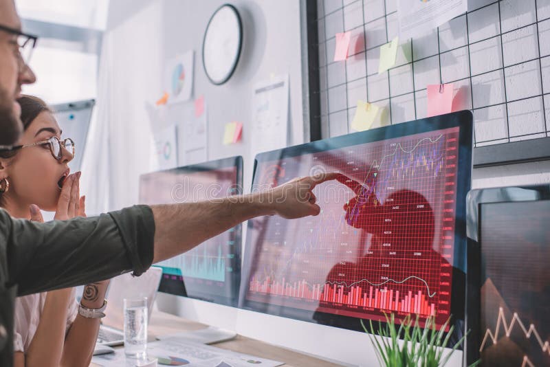 Selective focus of data analyst pointing on charts on computer monitor stock photos