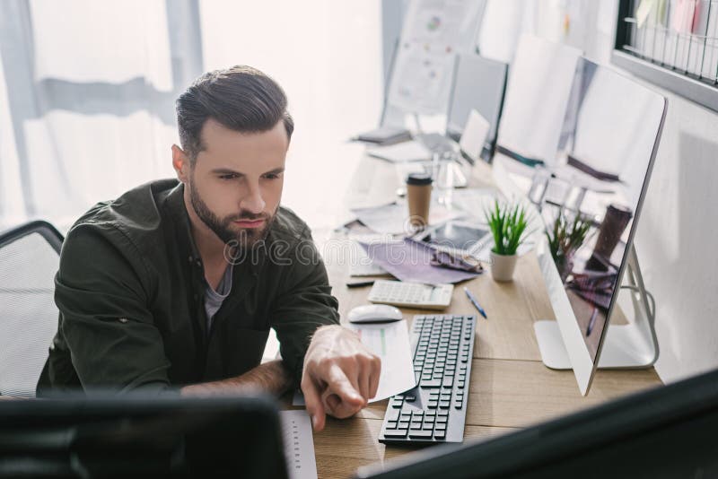 Selective focus of data analyst pointing on computer monitor while working royalty free stock photos