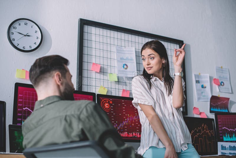 Selective focus of data analyst pointing with finger to colleague royalty free stock image