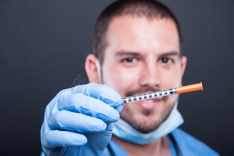 Selective focus of doctor wearing scrubs holding diabetes inject royalty free stock image