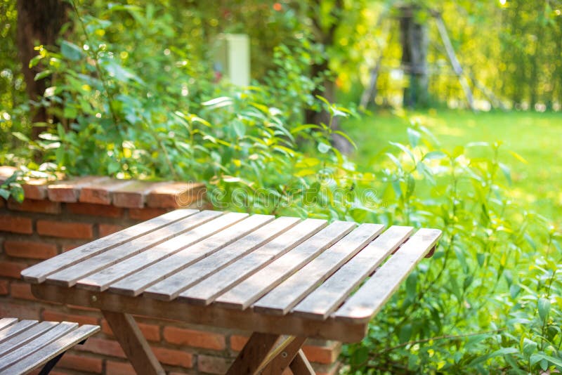 Selective Focus of Empty Wooden Table or Plank with Chair or Bench on  Background for Product Display. Stock Photo - Image of counter, grass:  163954030