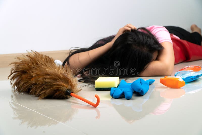 Selective focus of Feather duster.Asian housewives lie on the floor due to fatigue from household chores. With various cleaning eq royalty free stock photos Selective focus of Feather duster.Asian housewives lie on the floor due to fatigue from household chores. With various cleaning eq royalty free stock photos