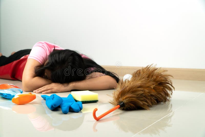 Selective focus of Feather duster.Asian housewives lie on the floor due to fatigue from household chores. With various cleaning eq stock images Selective focus of Feather duster.Asian housewives lie on the floor due to fatigue from household chores. With various cleaning eq stock images