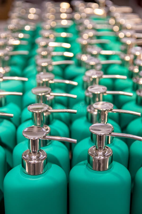 Selective focus on the front part of a group of green spray bottles in a market royalty free stock images