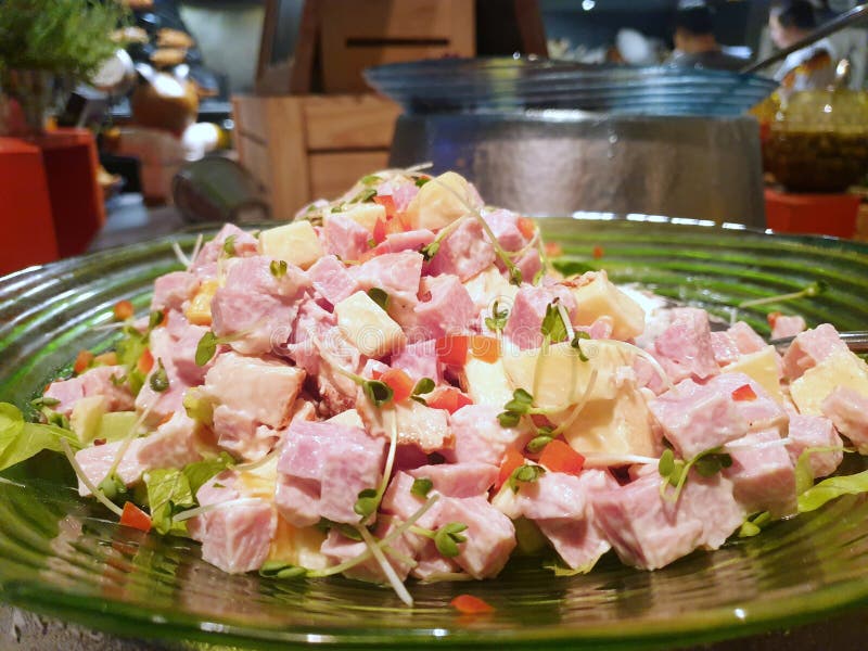 Selective focus of ham sausage salad with tomato, onion, sunflower seedlings and mayonnaise on plate in restaurant stock photos Selective focus of ham sausage salad with tomato, onion, sunflower seedlings and mayonnaise on plate in restaurant stock photos