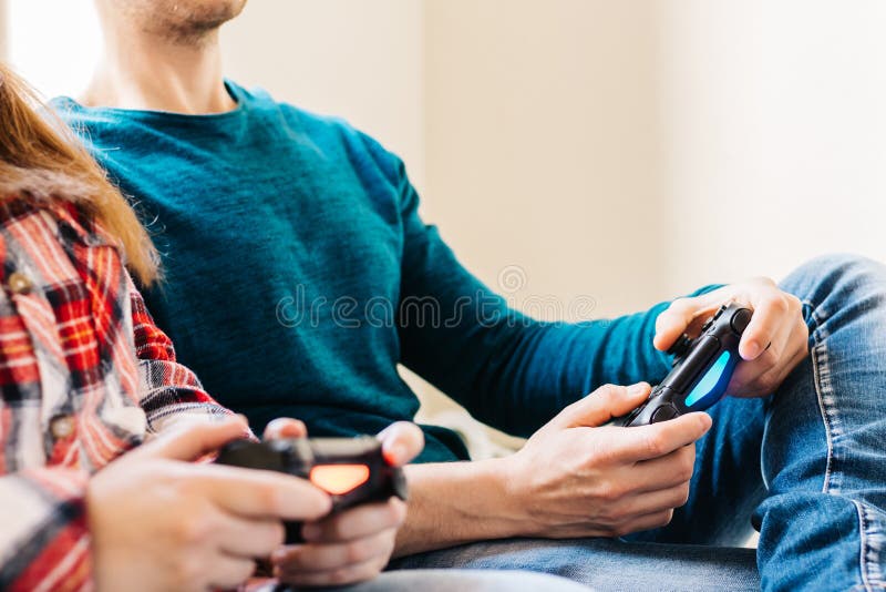 Man disappointed while playing video game with girlfriend at home stock  photo