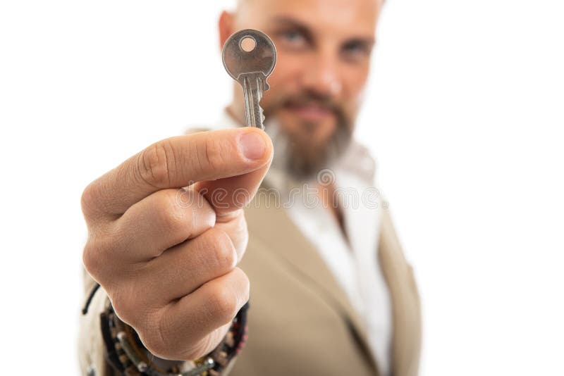 Selective focus of man wearing smart casual holding one key royalty free stock images