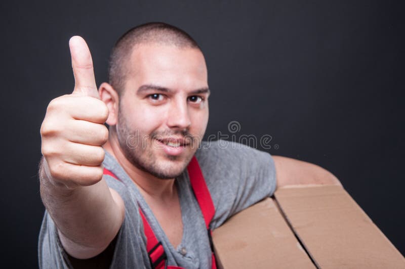 Selective focus of mover guy holding box showing like stock photo