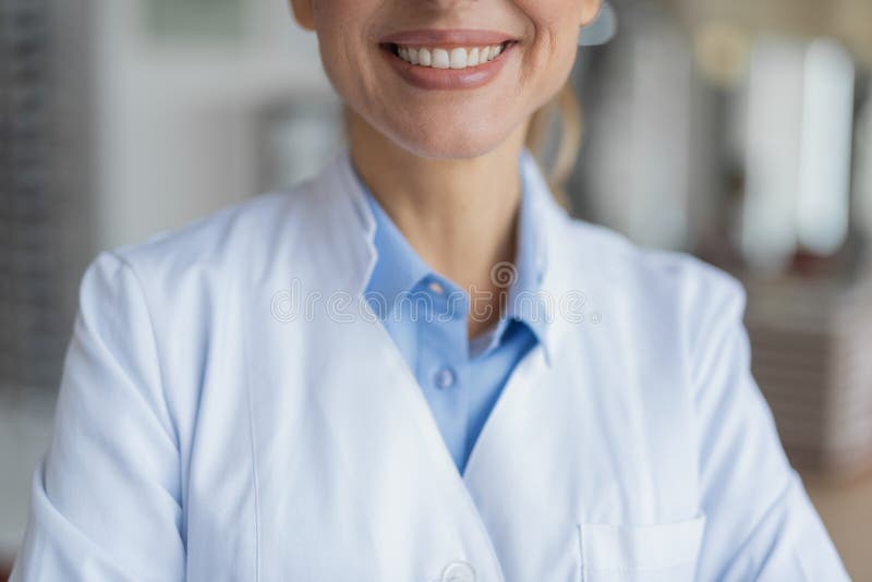Selective focus of a pleasant female doctor smiling stock photo Selective focus of a pleasant female doctor smiling stock photo
