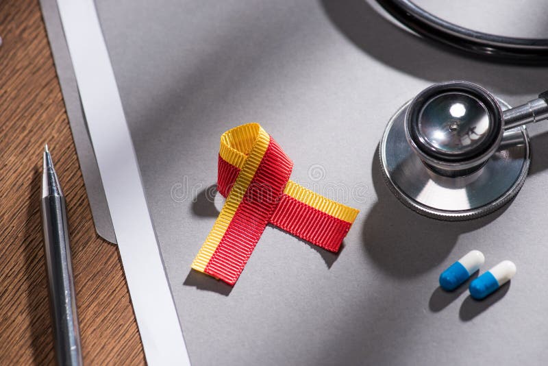 Selective focus of ribbon stethoscope pills and folder with pen on table world hepatitis royalty free stock image
