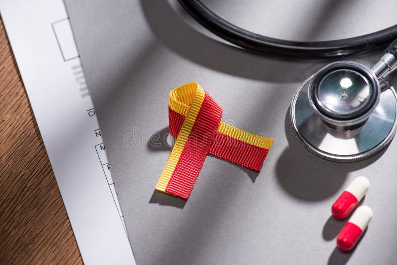 Selective focus of ribbon stethoscope pills and folder on table world hepatitis stock image