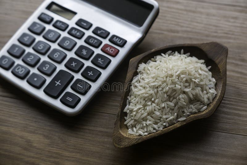 Concept of zakat in Islam religion. Selective focus of money and rice with  alphabet of zakat on wooden background.