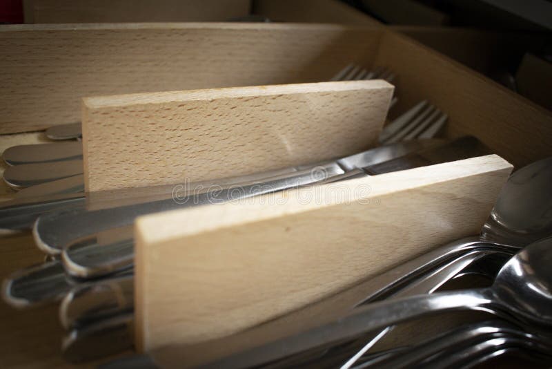 Selective focus shot of cutlery organized in a kitchen drawer