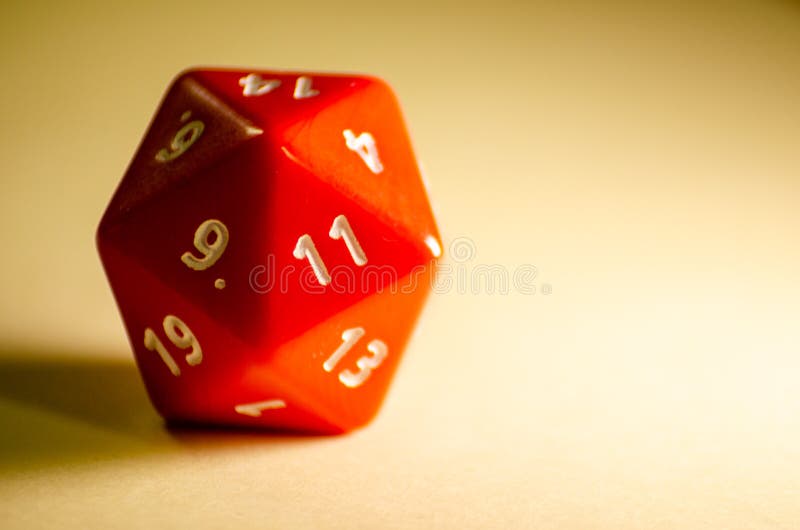 Selective focus 20-sided red dice for role-playing game isolated on warm background royalty free stock images