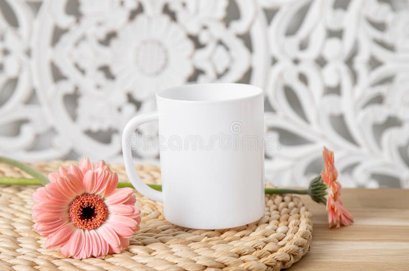 Selective focus on single one white mug mock up with spring flowers.