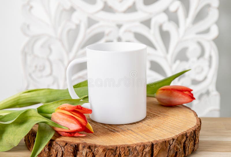 Selective focus on single one white mug mock up with spring flowers.