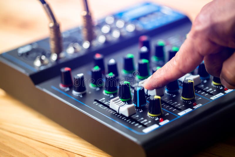 Selective focus to sound electronics mixer and equalizer with hand to turning and adjusting button and slide volume stock image