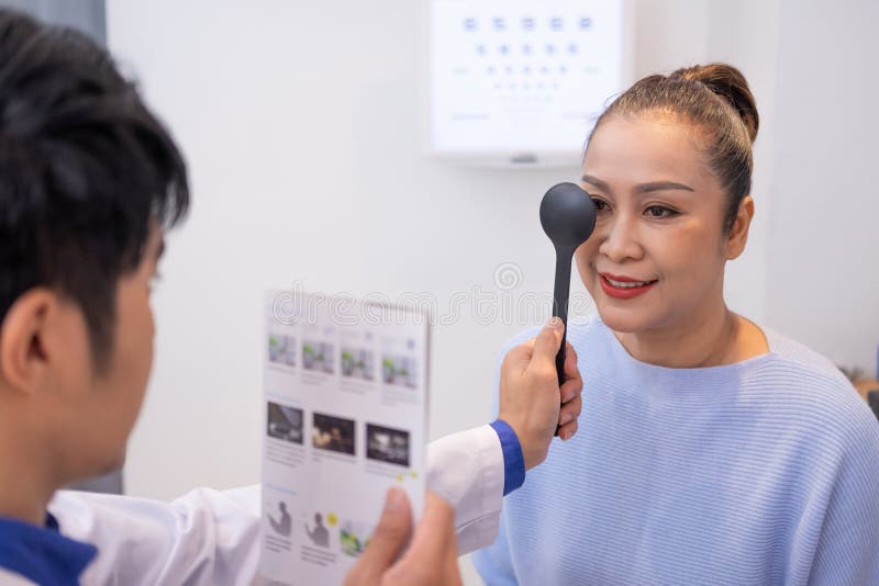 Selective Focus at Women Face. while Doctor Using Optometry Equipment