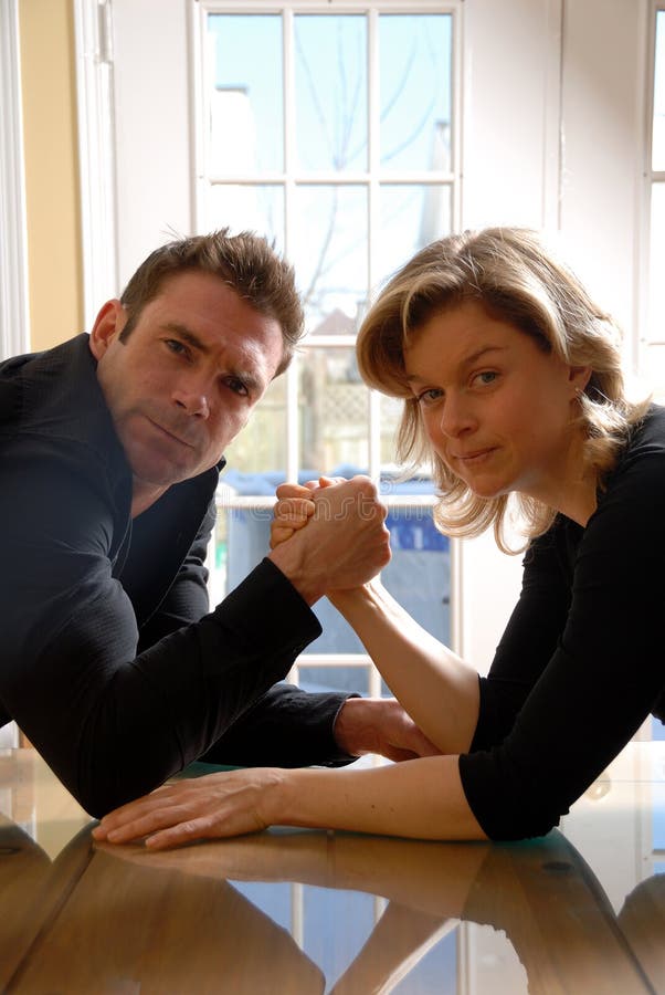 Man and a woman ready to arm wrestle. Man and a woman ready to arm wrestle