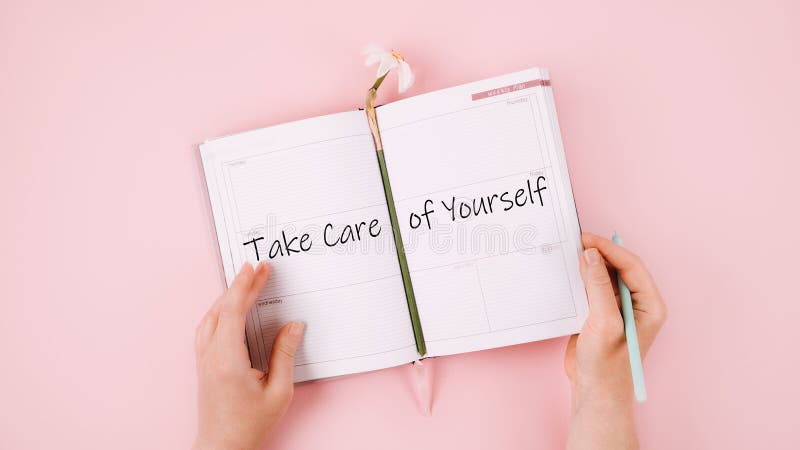 Self Care, Take care of yourself, wellbeing routine, self-care activities concept with open notebook, flower narcissus and female hand on pink background.