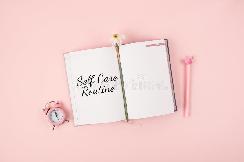 Self Care, wellbeing Routine, holistic set of self-care activities concept with open notebook, flower narcissus and alarm clock on