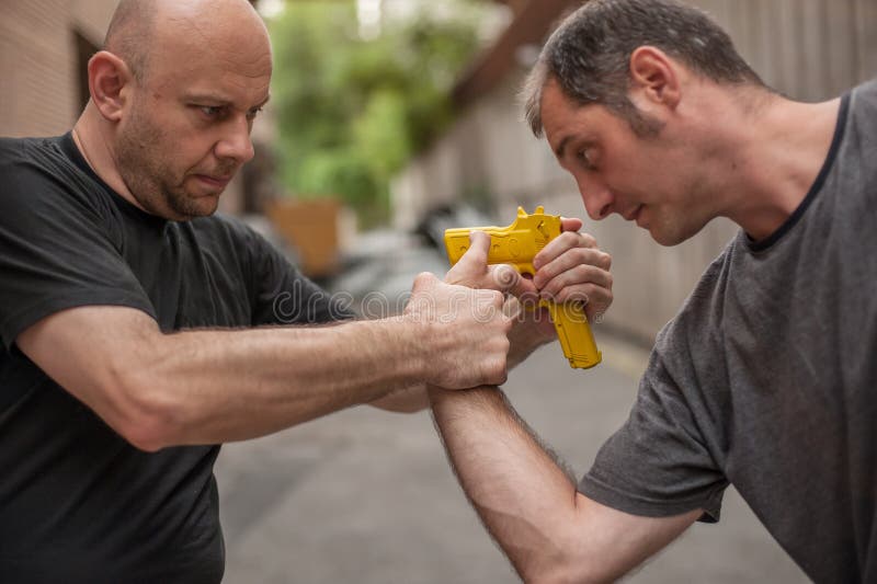 Self Defense Techniques Against a Gun Stock Photo Image of disarming
