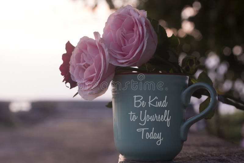 Self love and care inspirational quote on coffee cup - Be kind to  yourself today. With pink roses and coffee cup vase decoration.