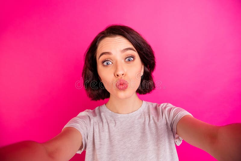 Self portrait of pretty cute charming fascinating girlfriend kissing you through air while recording video taking selfie