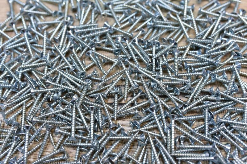 Self-tapping screw for working with wood products and surfaces. Hardware, fasteners and materials for construction and repair. stock images