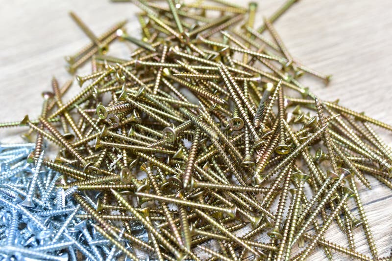 Self-tapping screw for working with wood products and surfaces. Hardware, fasteners and materials for construction and repair. royalty free stock photography