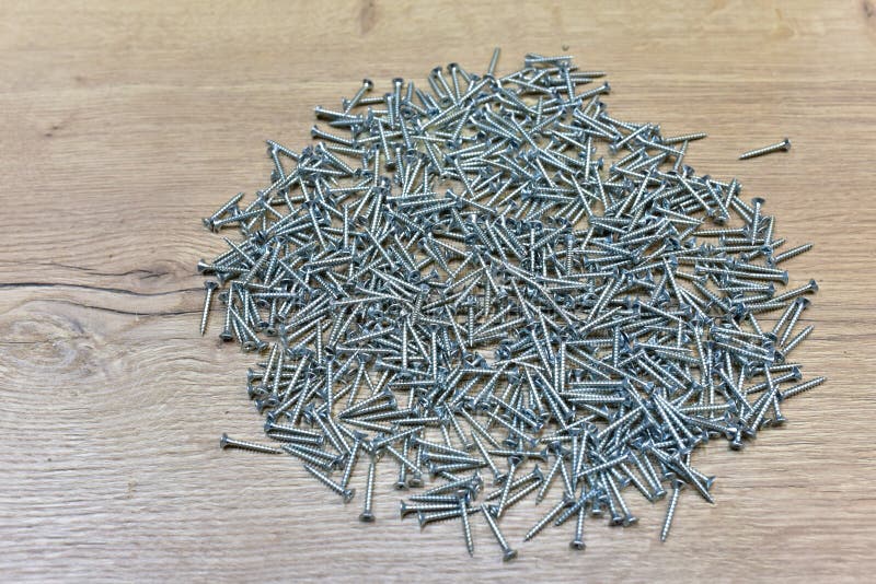 Self-tapping screw for working with wood products and surfaces. Hardware, fasteners and materials for construction and repair. stock photography