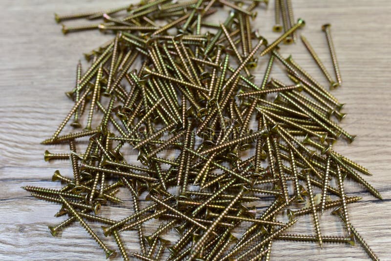 Self-tapping screw for working with wood products and surfaces. Hardware, fasteners and materials for construction and repair. royalty free stock images