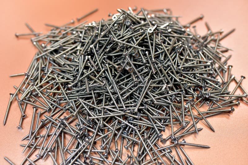 Self-tapping screw for working with wood products and surfaces. Hardware, fasteners and materials for construction and repair. stock photos