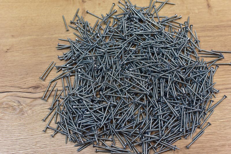 Self-tapping screw for working with wood products and surfaces. Hardware, fasteners and materials for construction and repair. stock image