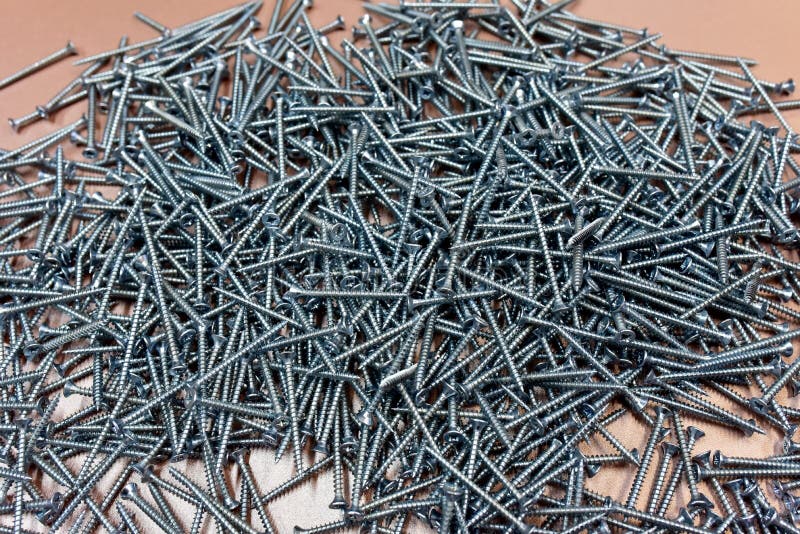 Self-tapping screws. Screw for working with wood products and surfaces. Hardware, fasteners and materials for construction and royalty free stock photos